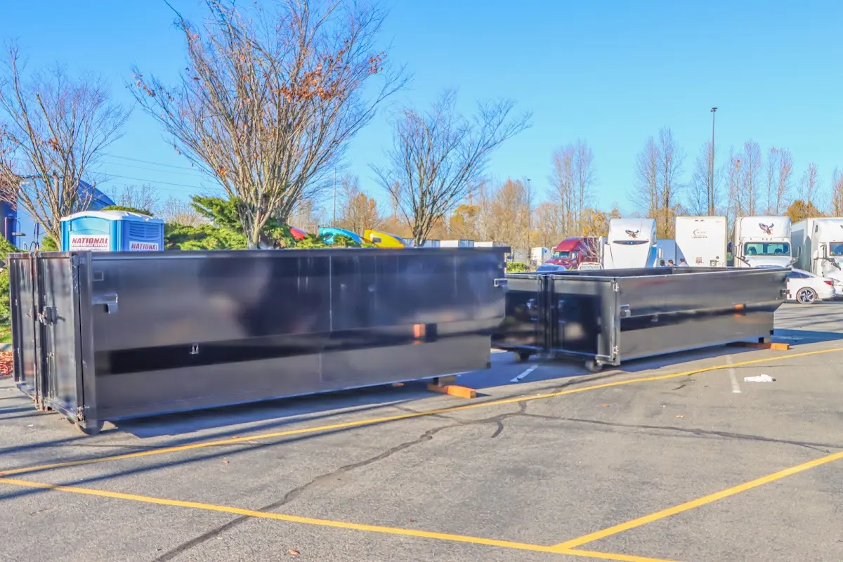 Professional dumpster rental service with roll-off container on residential driveway in Yorktown